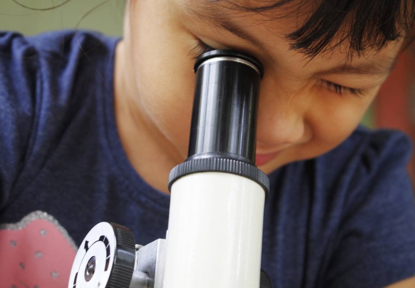 Child looking through microscope