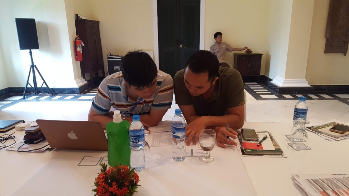 Two staff from Vietnam team red listing trees