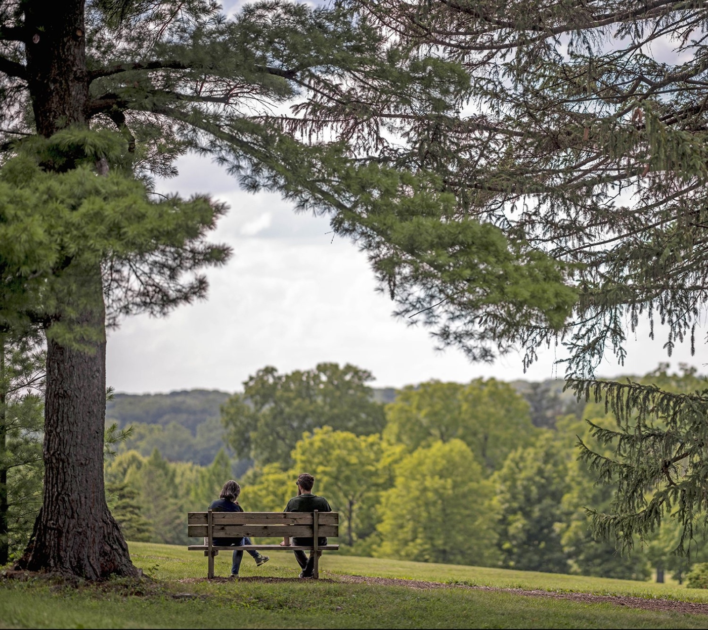 Couple sits on a bench at Frost Hill in Summer