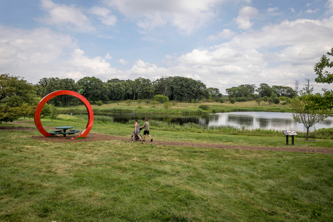 Family walks by the crabapple collection in the summer