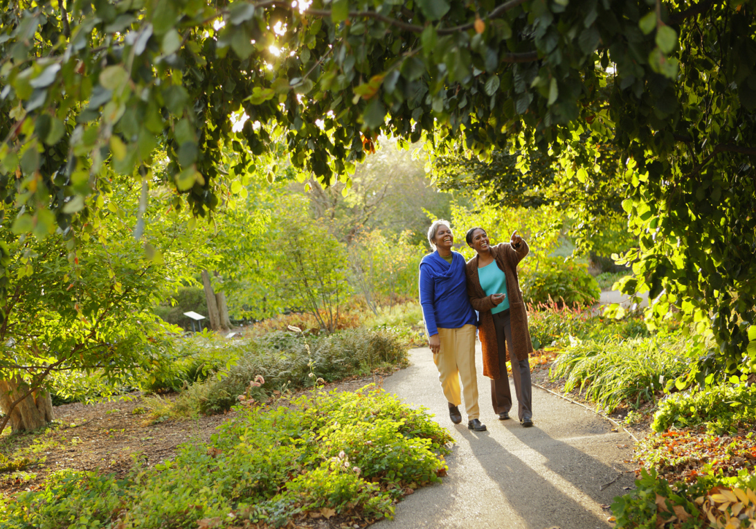 Mother and daughter walk through the Ground Cover Garden in Summer