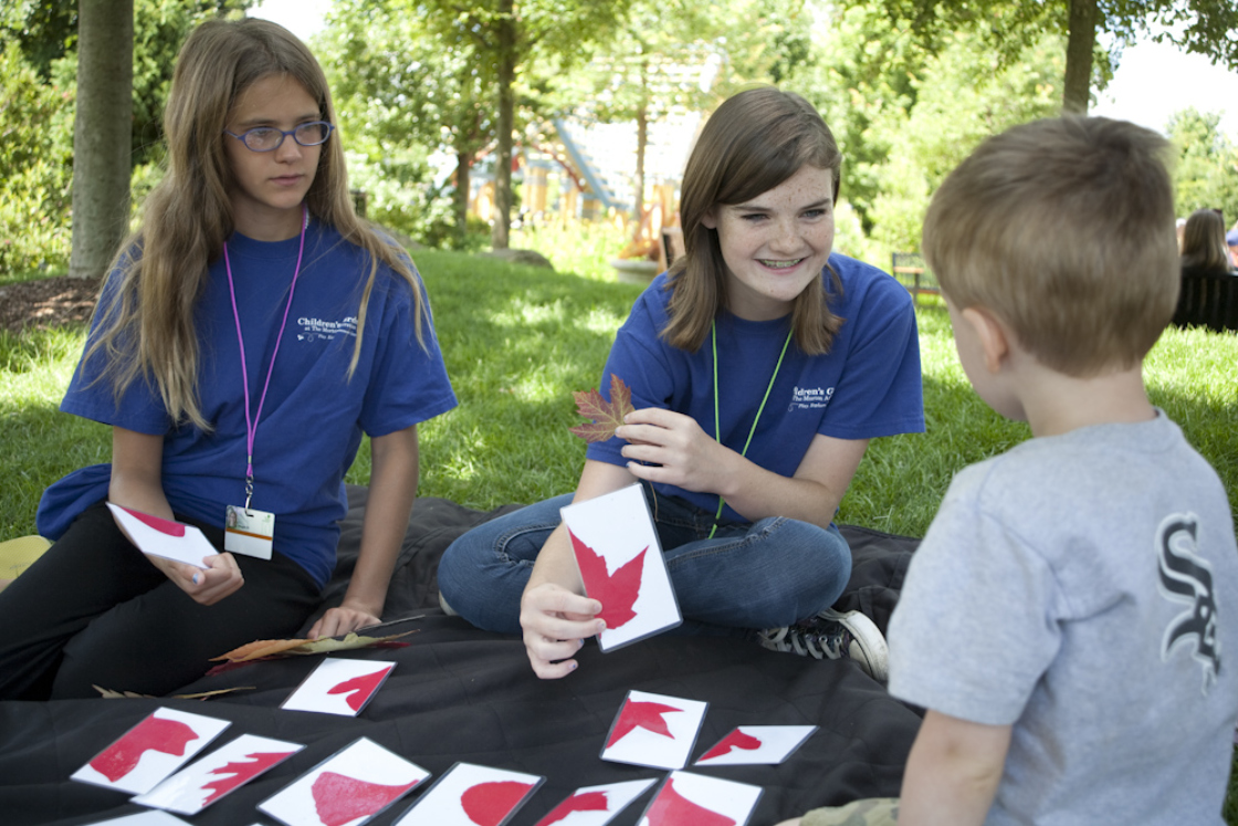 Youth volunteers working with kids in the children's garden.