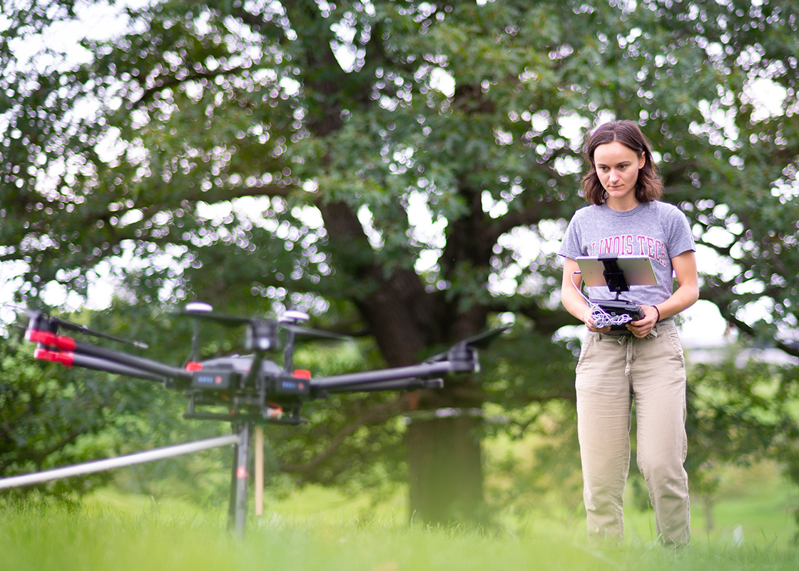 REU Intern flying a drone