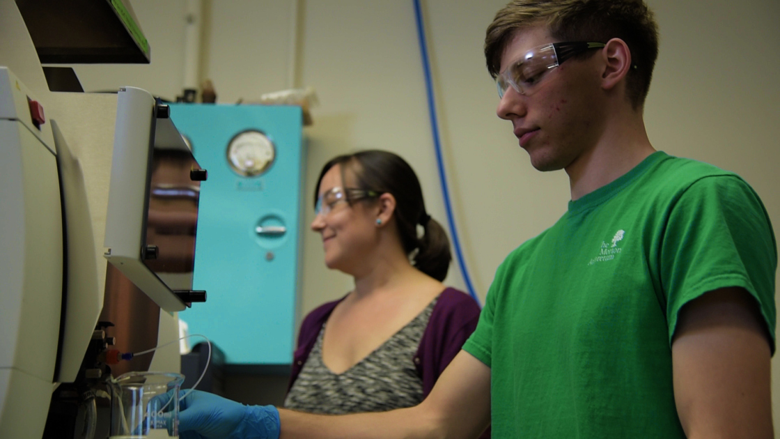 Researchers measuring sodium leachate concentrations on an atomic adsorption spectrophotometer