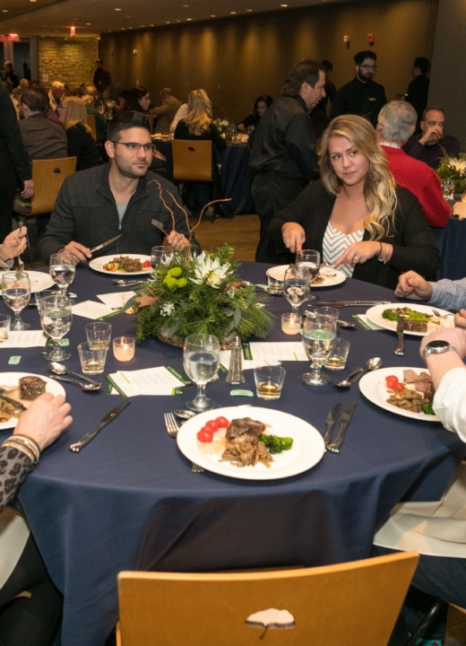 Friends eat and drink at the Whiskey Dinner