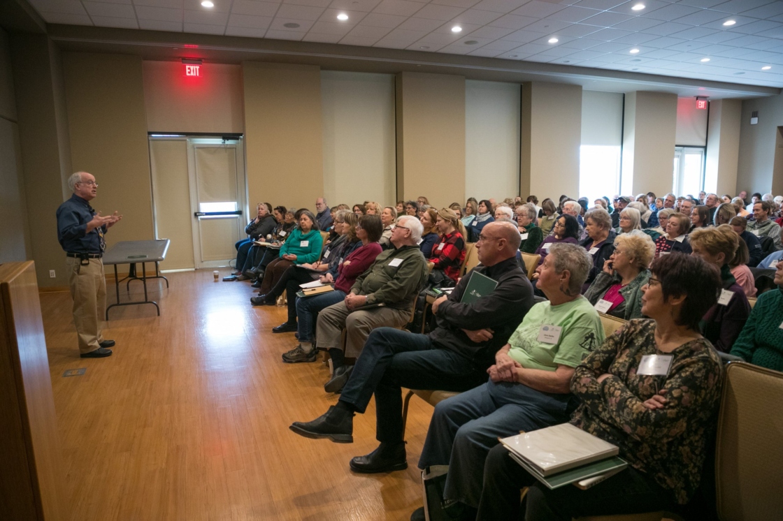 Presenter talks to a room of professionals