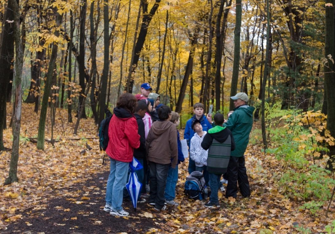 Group of students with teacher in fall woods
