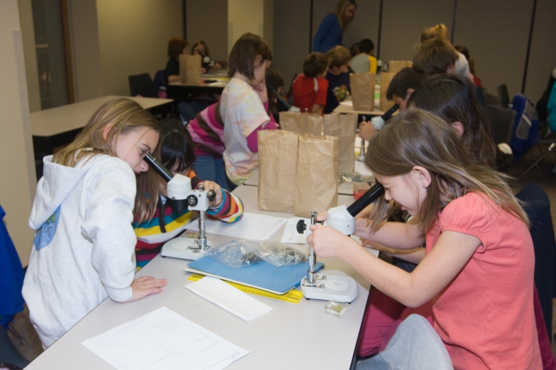 Students using microscopes in a classroom