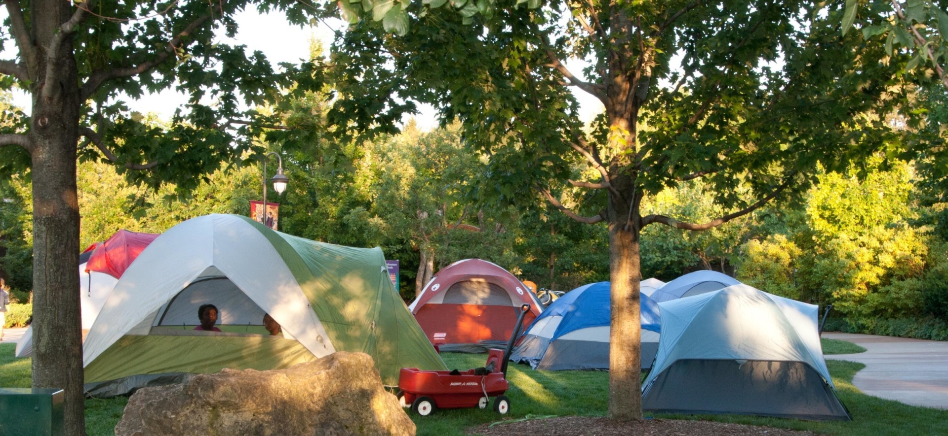 Several tents set up in the Children's Garden for a campout.