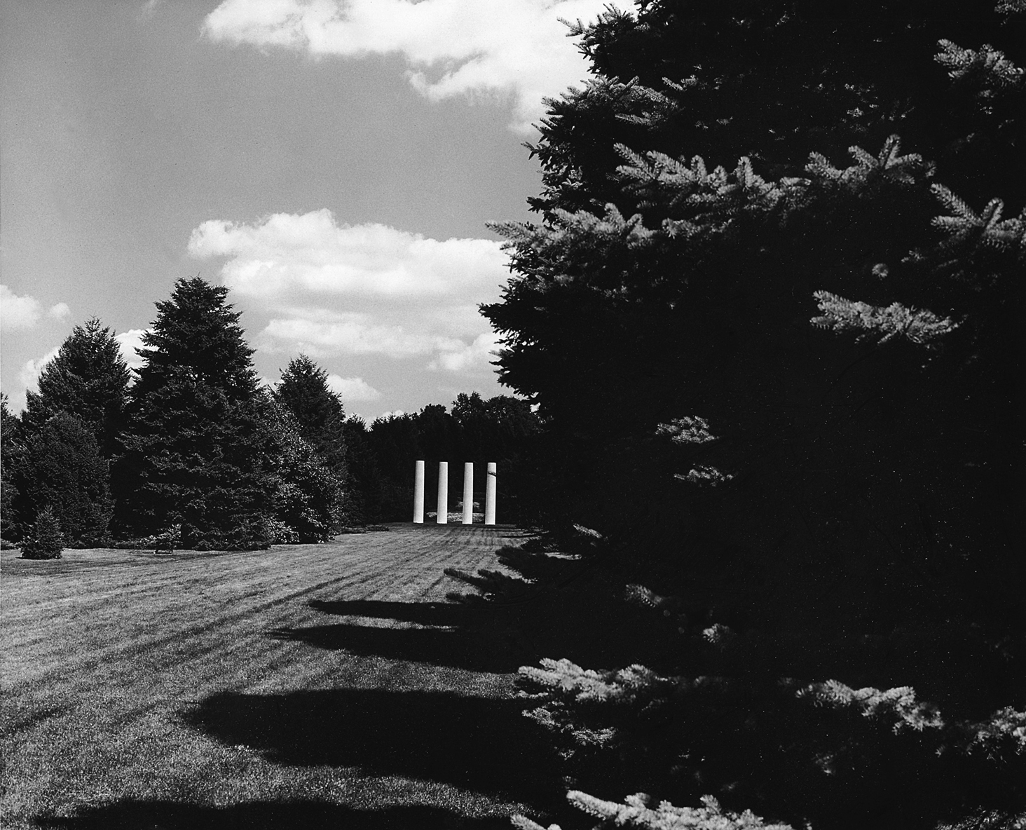 Historic black and white image of the four columns