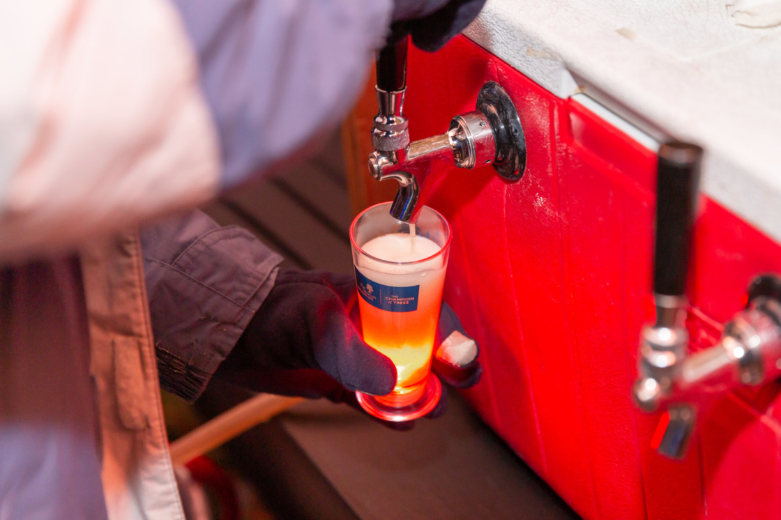 Brewer pours beer at IllumiBrew