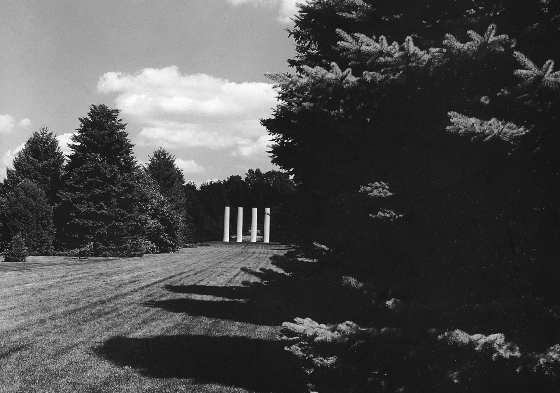 Black and white photo of the four columns and hedge garden