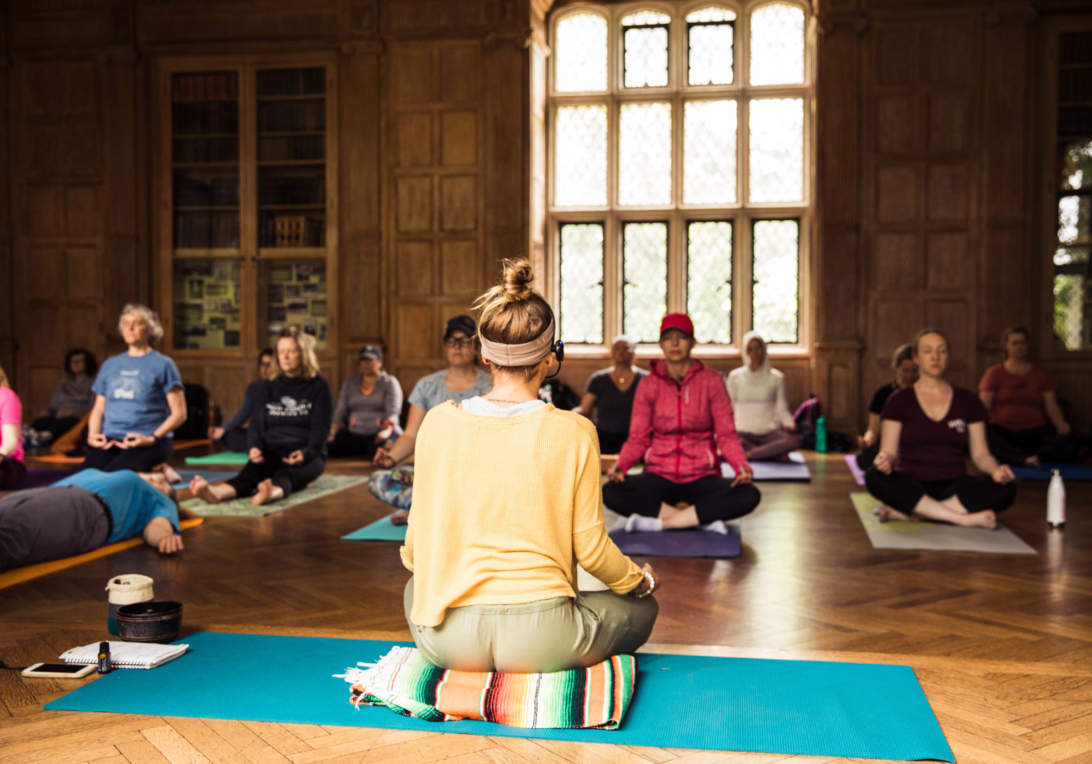 Yoga instructor Natalie Schilke leads an indoor yoga class at The Morton Arboretum in the Founders Room at Thornhill Education Center.