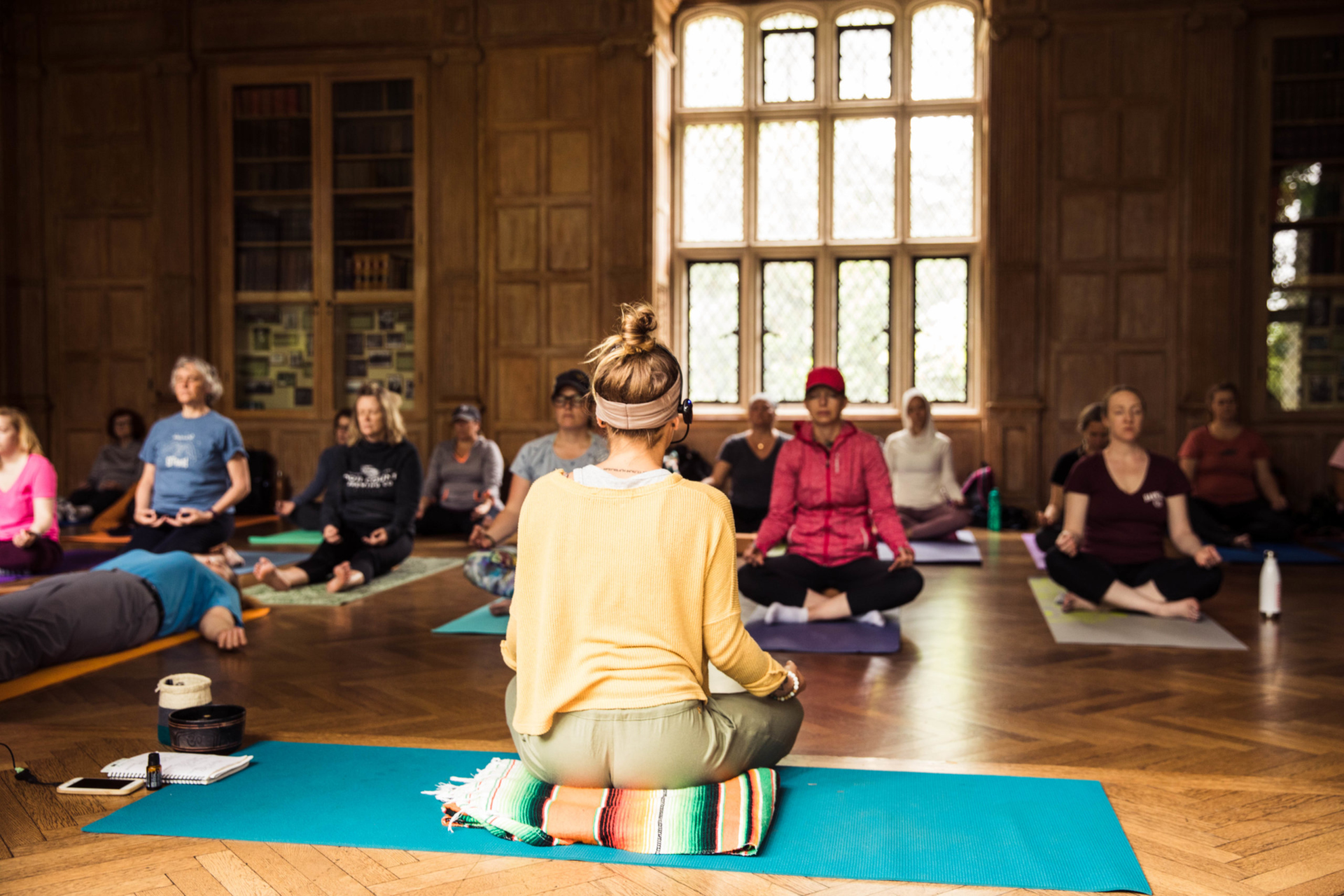 Yoga instructor Natalie Schilke leads an indoor yoga class at The Morton Arboretum in the Founders Room at Thornhill Education Center.
