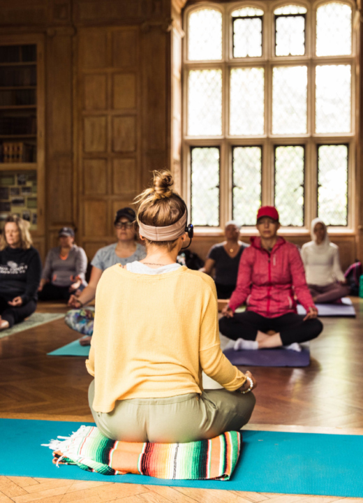 Yoga instructor Natalie Schilke leads an indoor yoga class at The Morton Arboretum in the Founders Room at Thornhill Education Center.