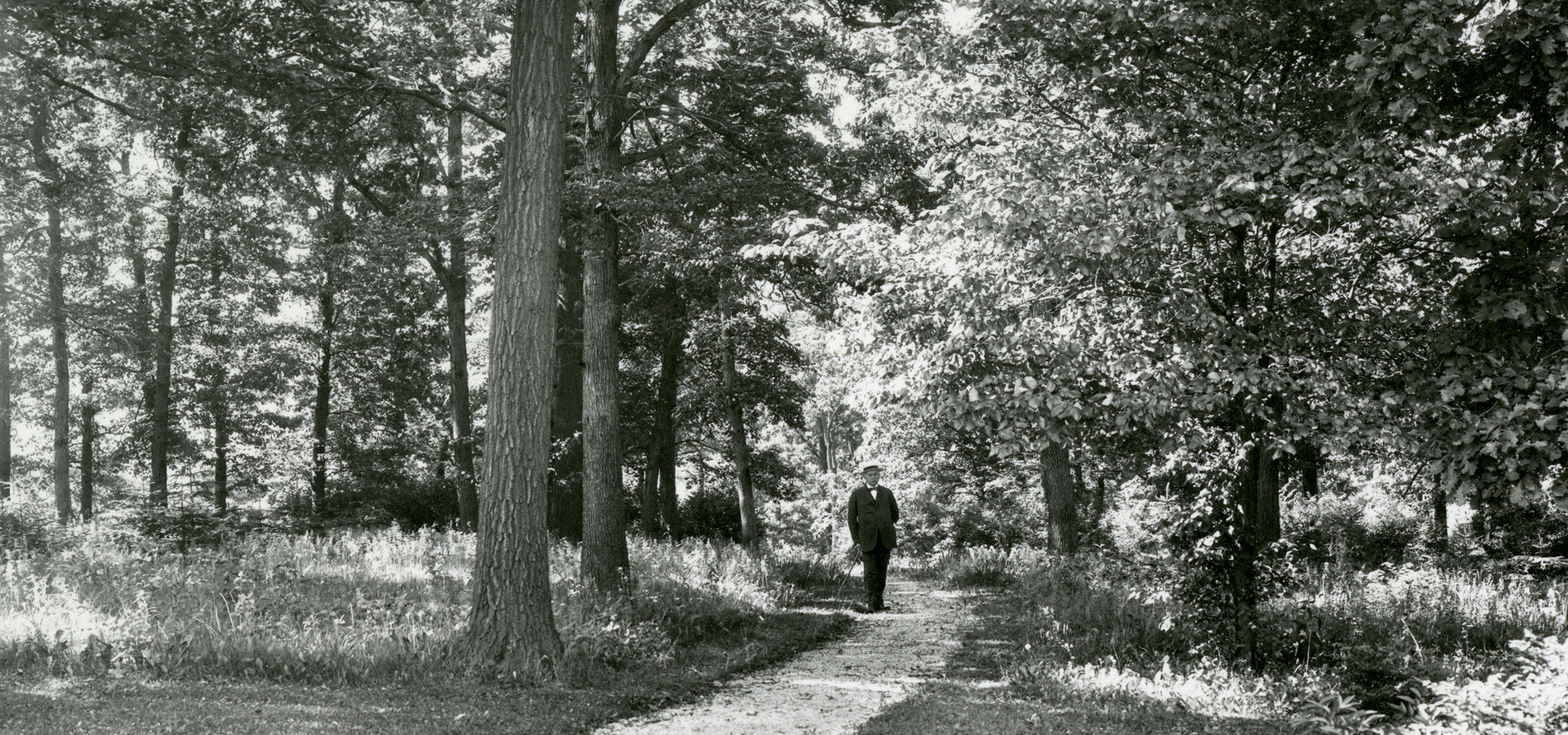 Black and white image of Joy Morton walking on Joy Path