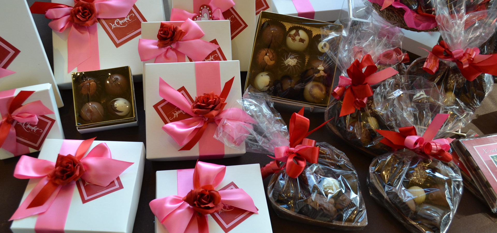 Arrangement of chocolates and candies with decorative packaging and ribbons