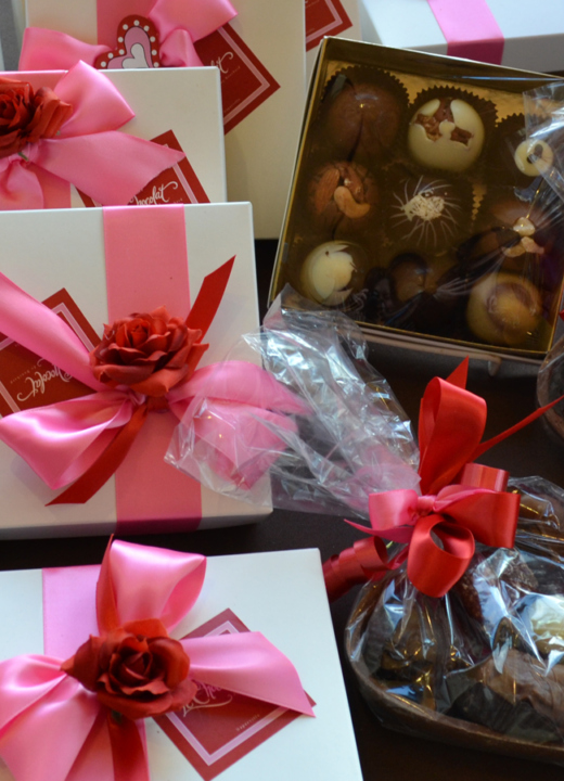 Arrangement of chocolates and candies with decorative packaging and ribbons
