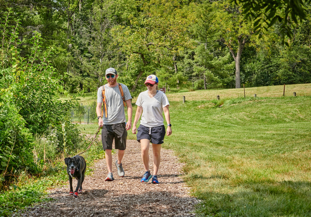 A couple explore the chipped trails with their dog