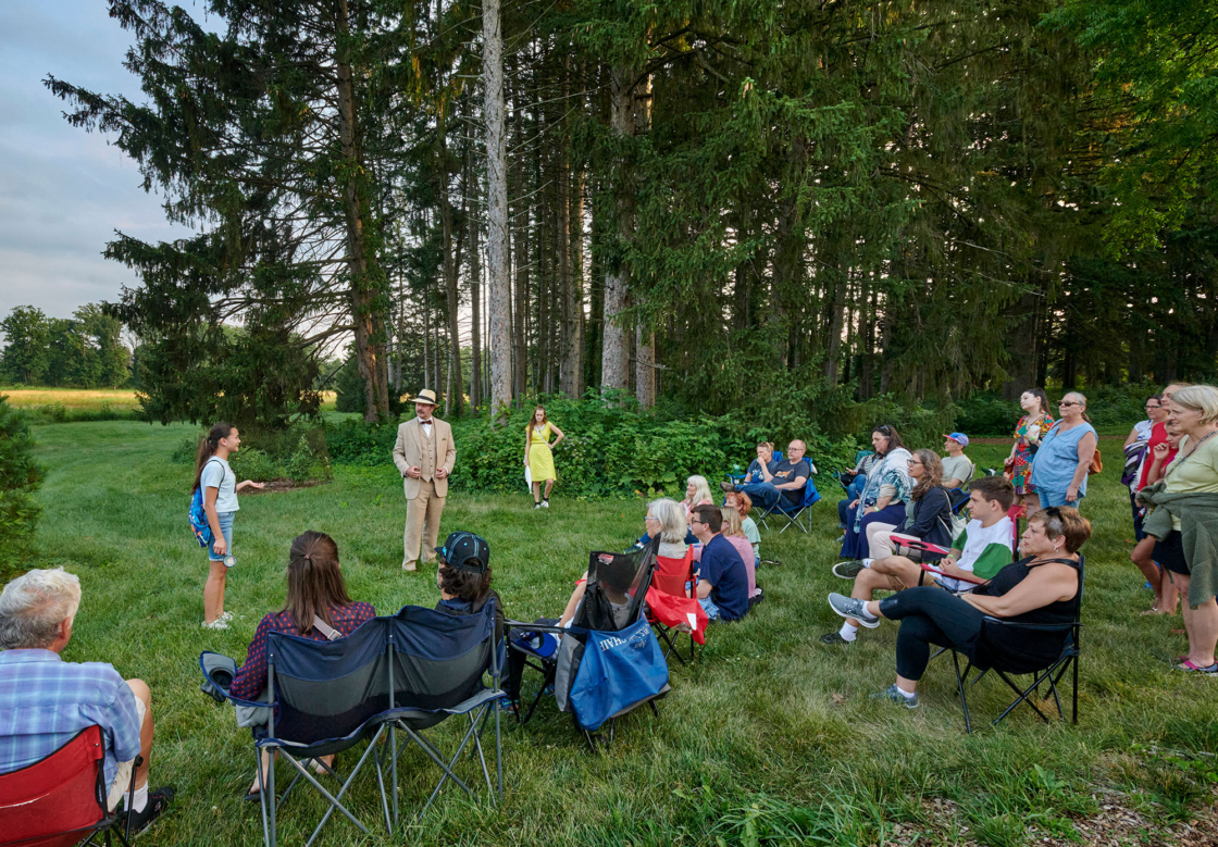 Guests gather around the Walking Play performers
