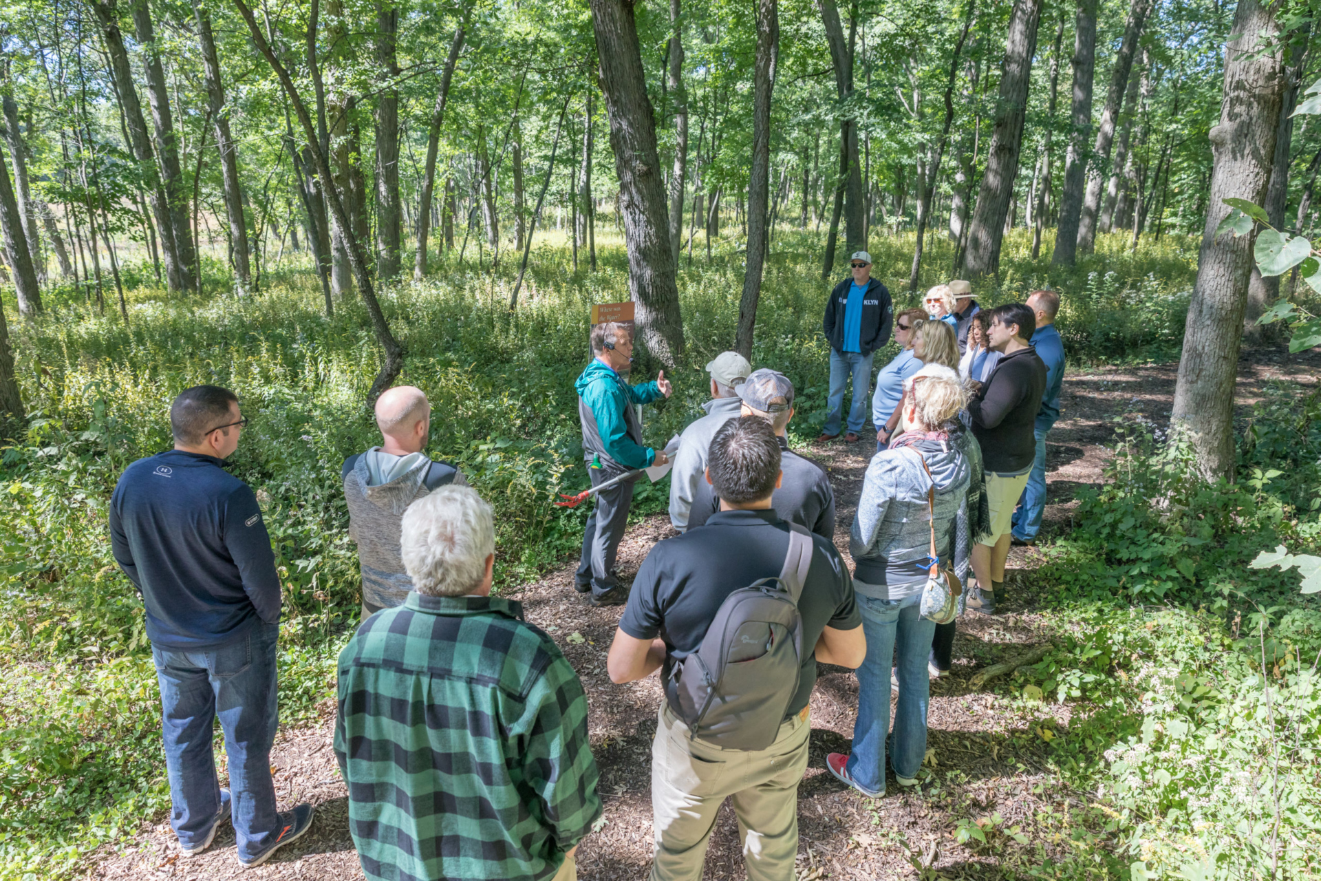 Kris Bachtell leads a group on a hike to learn about oaks and their connection to the making of whiskey.