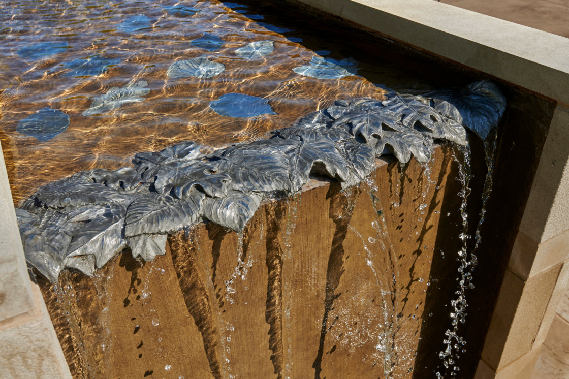 The leaves of trees are a motif throughout the garden, in fountains, arbors, and paving