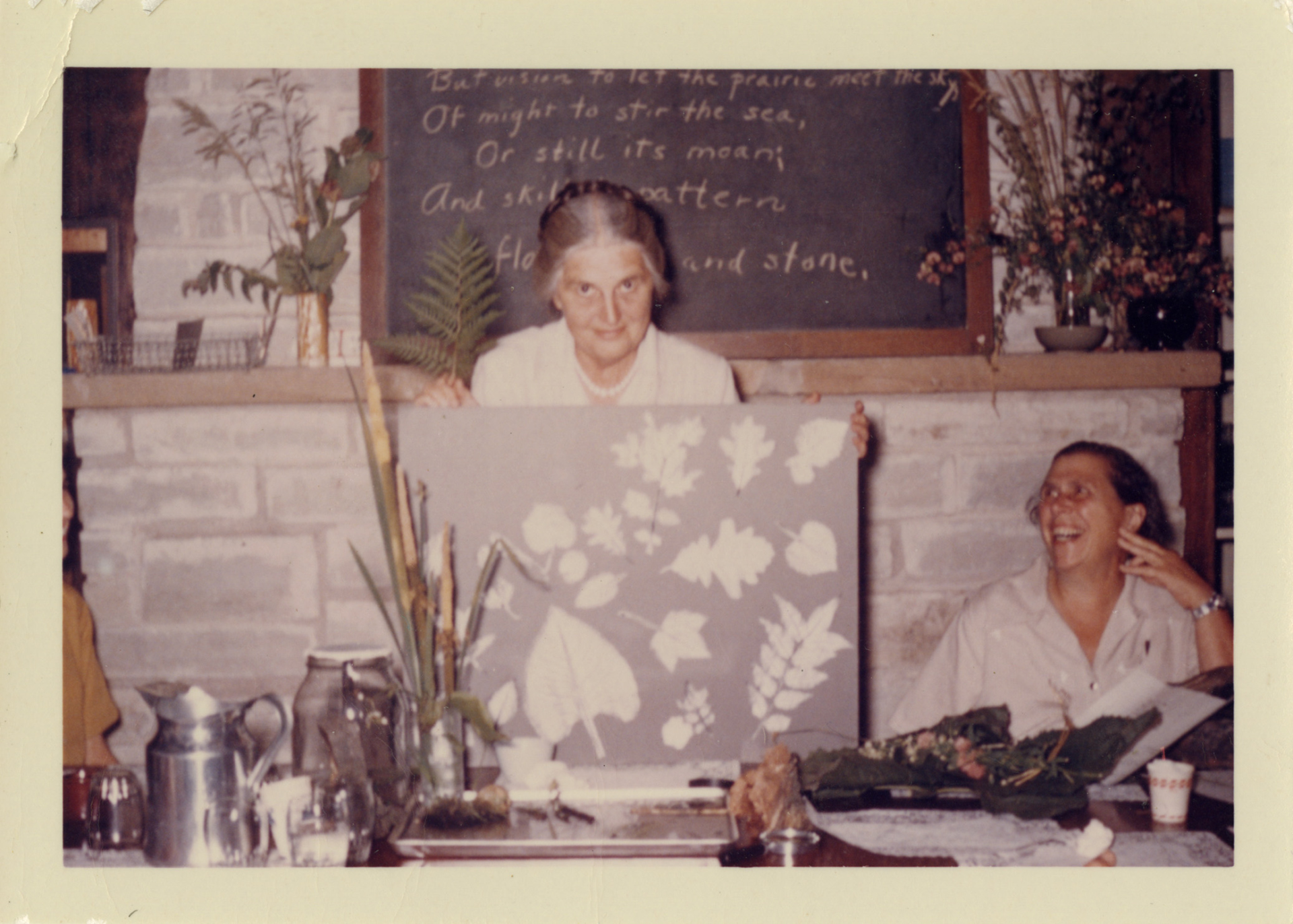 May watts holding up a print at a class she taught at the Arboretum.