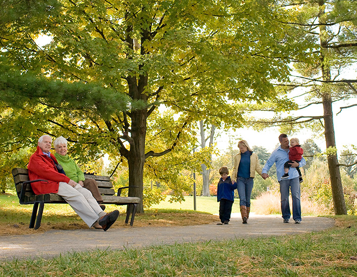 Families walk and sit around Meadow Lake in Fall