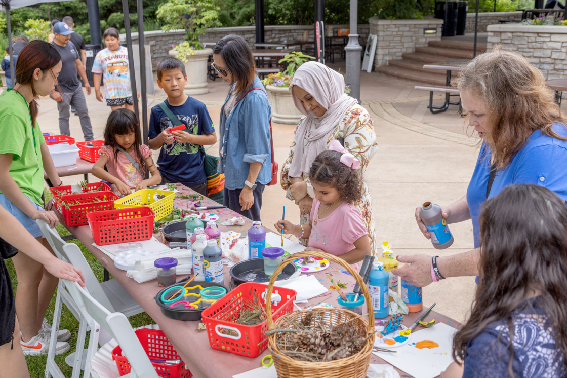 Families stop at a table in the Children's Garden to work on fun art projects.