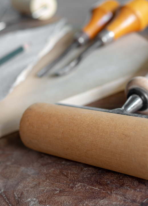 An array of woodcutting tools including carving tools and a roller.