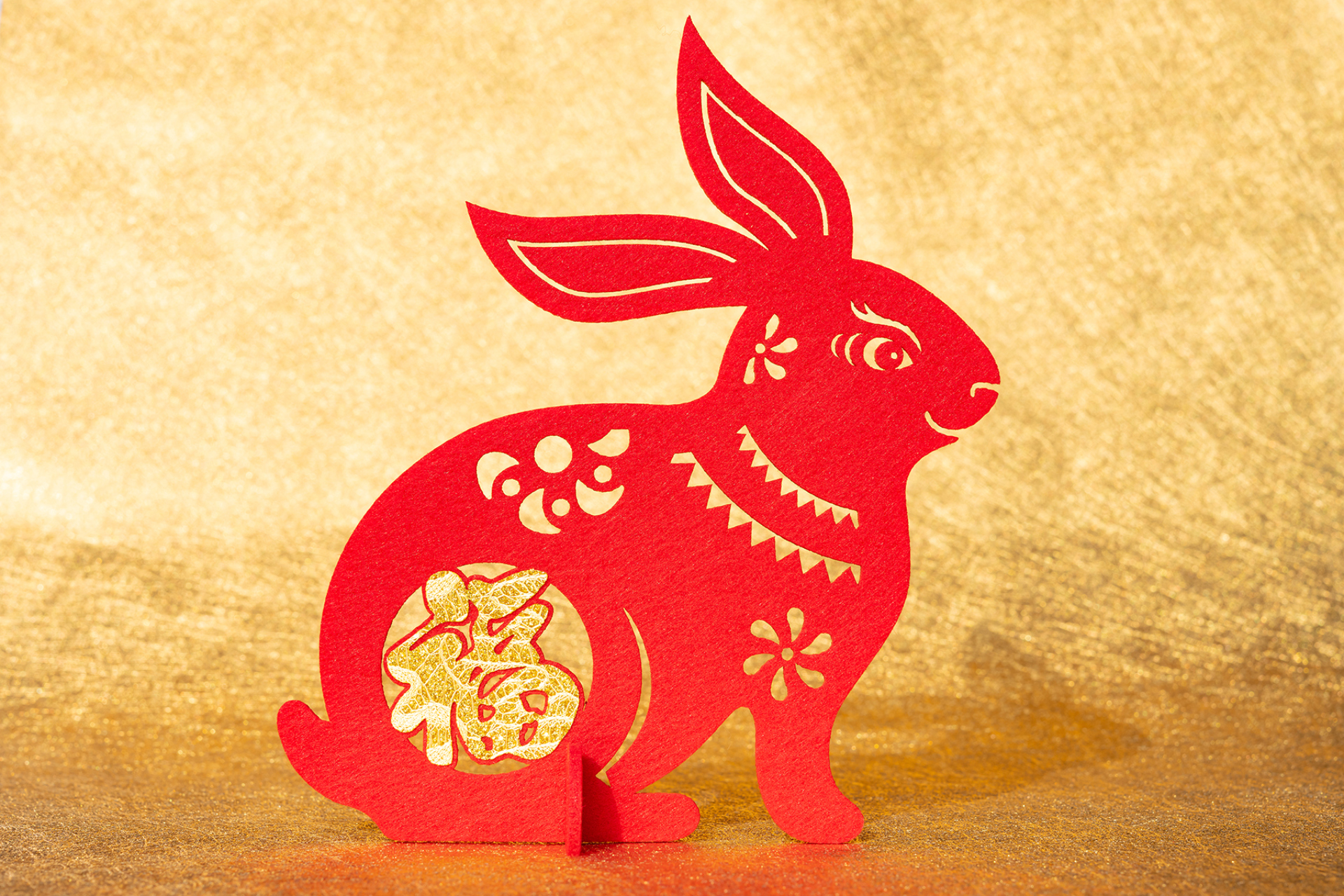 Chinese New Year of Rabbit mascot paper cut on golden background the Chinese symbol means fortune