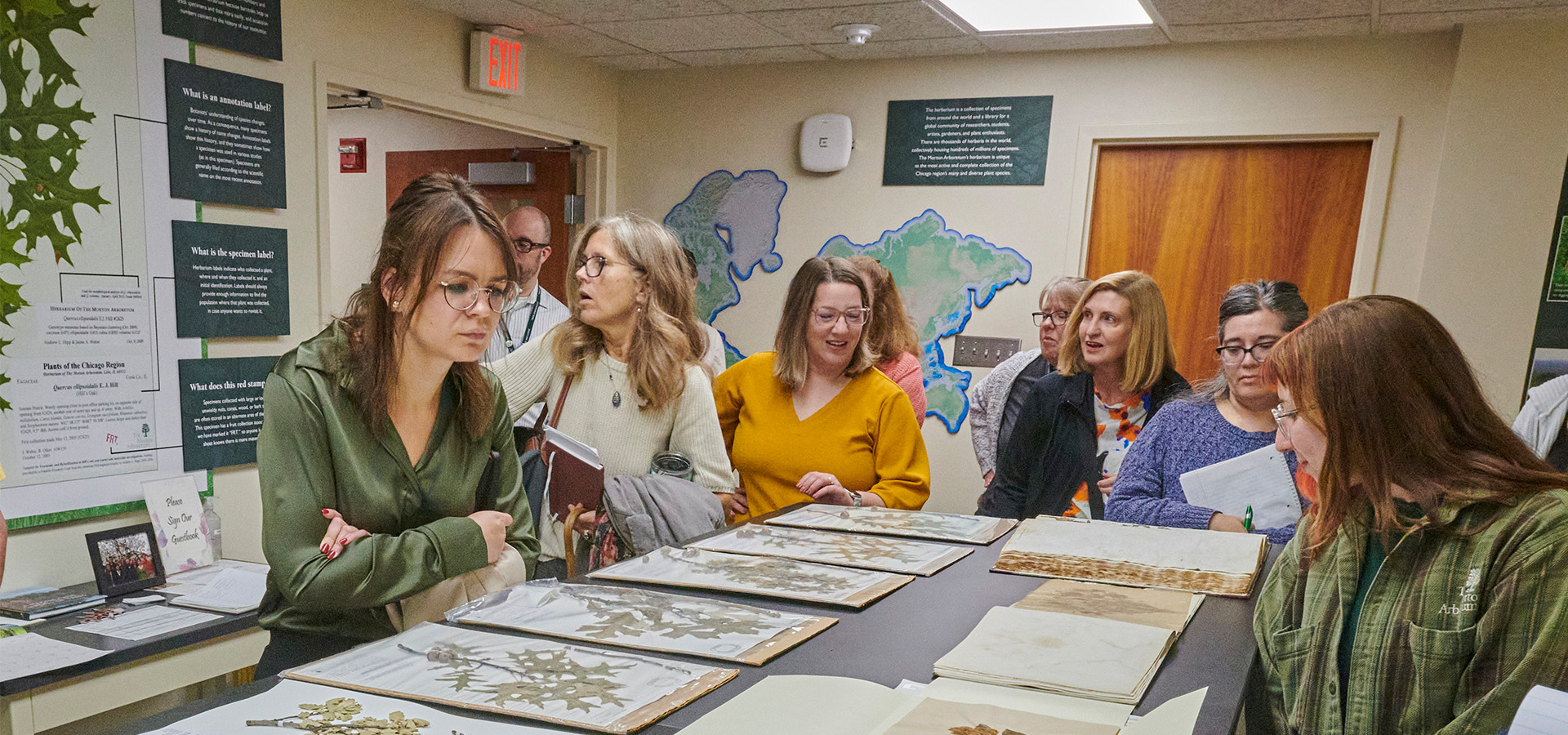 A group looking at dried plant samples in the Herbarium.