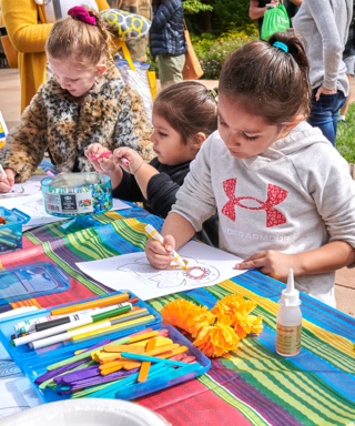 Photo of children participating in coloring and craft activities at the Children's Garden at The Morton Arboretum