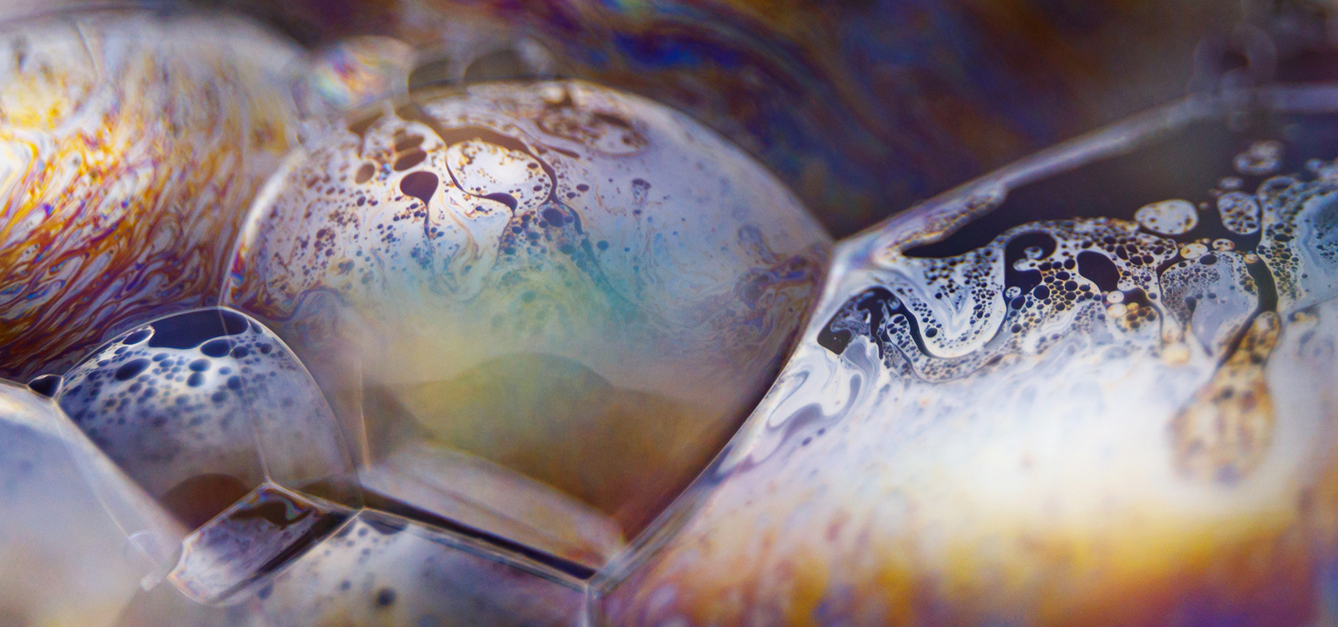 Macro photography picture of a bubble displaying psychedelic and natural patterns