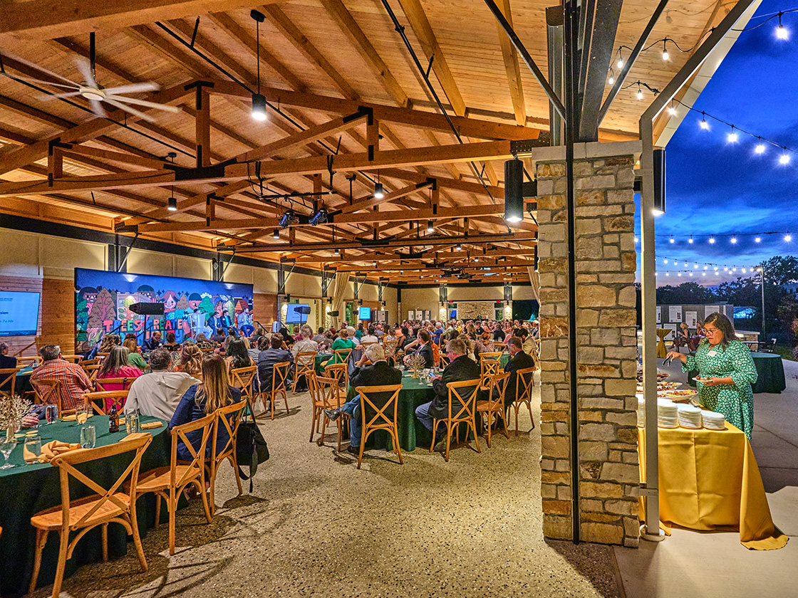 Guests enjoy an outdoor evening event at the Firefly Pavilion