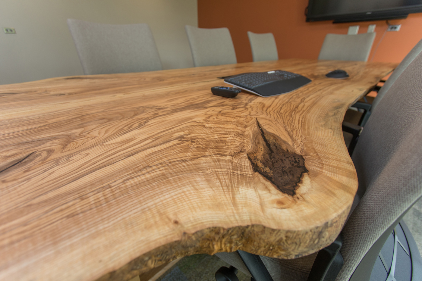 Elm tabletop with a prominent knot and wavy grain pattern