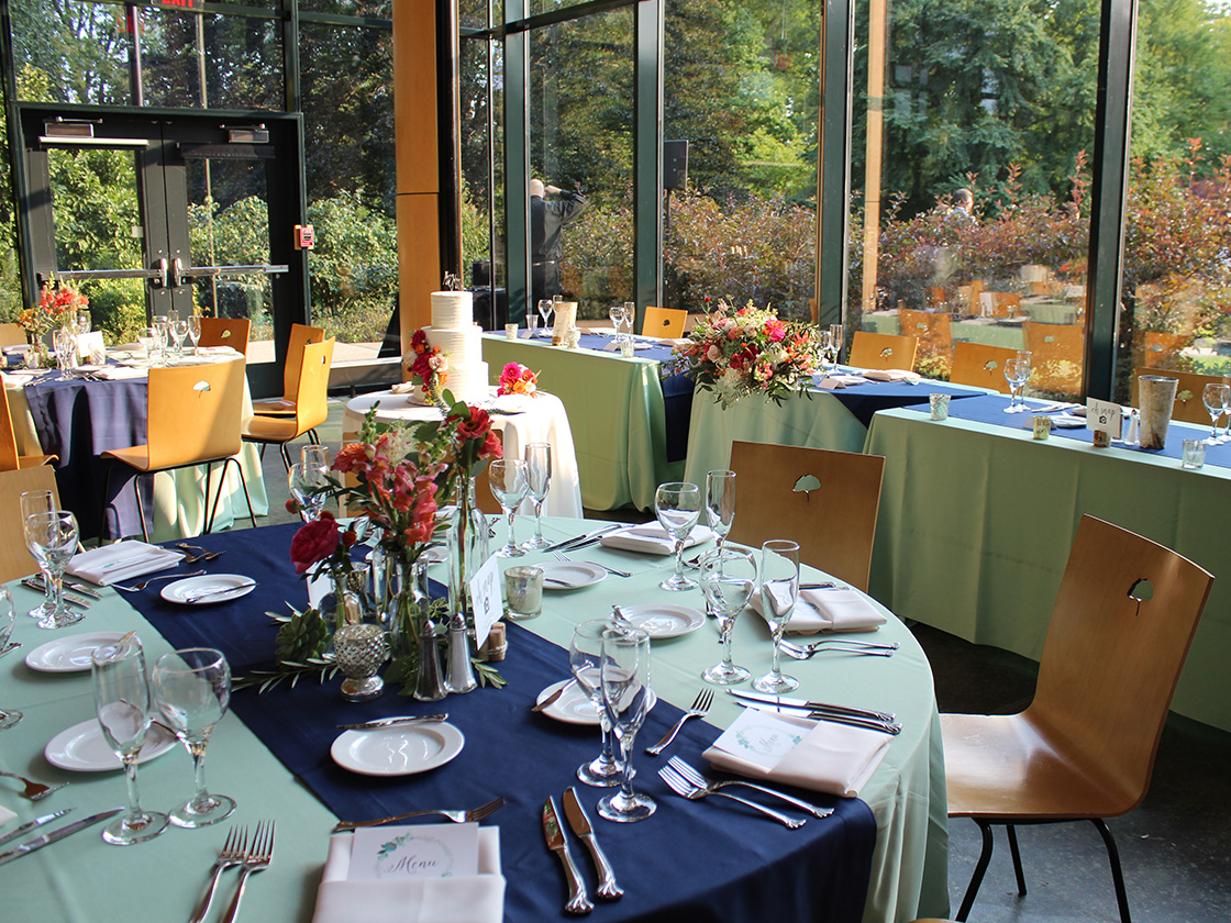 Dinner tables set for a private event in the Sycamore Room