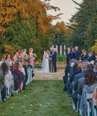 Wedding ceremony in front of the Four Columns sculptures in the Grand Garden