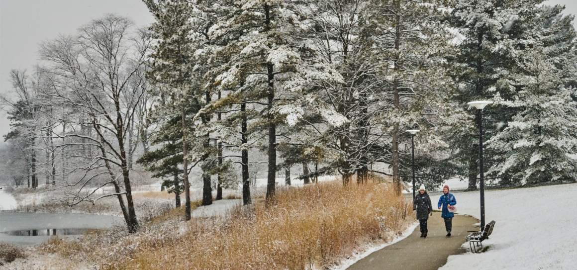 Photograph of two visitors walking on Meadow Lake on a winter day
