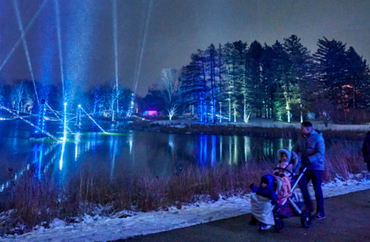 Families enjoying one of the holiday light displays on the Illumination trail around Meadow Lake