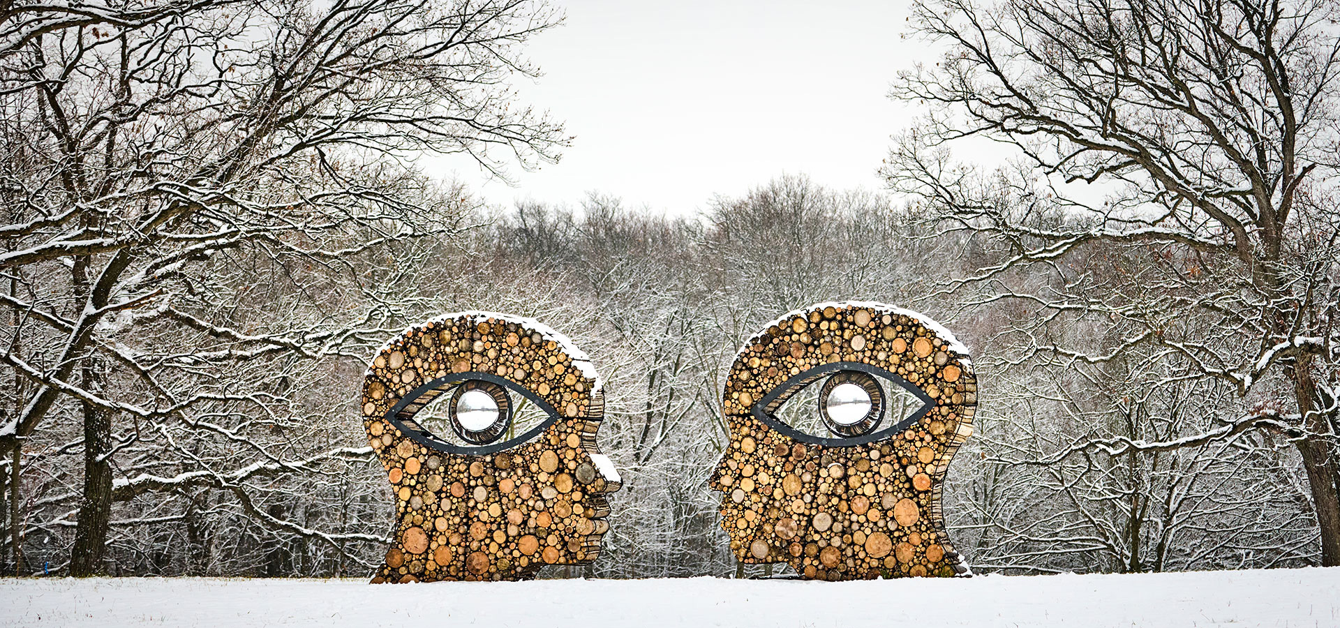 A photograph of the sculpture Oculus covered in snow, part of the Of the Earth art exhibition