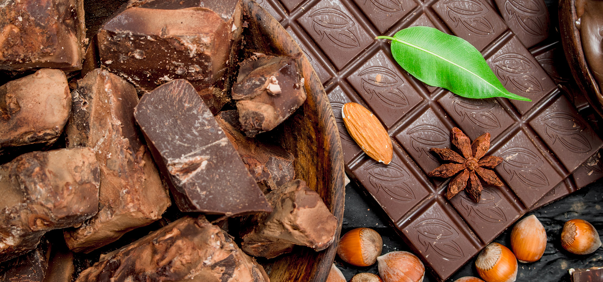 Close up photograph of chocolate bar and hazelnuts