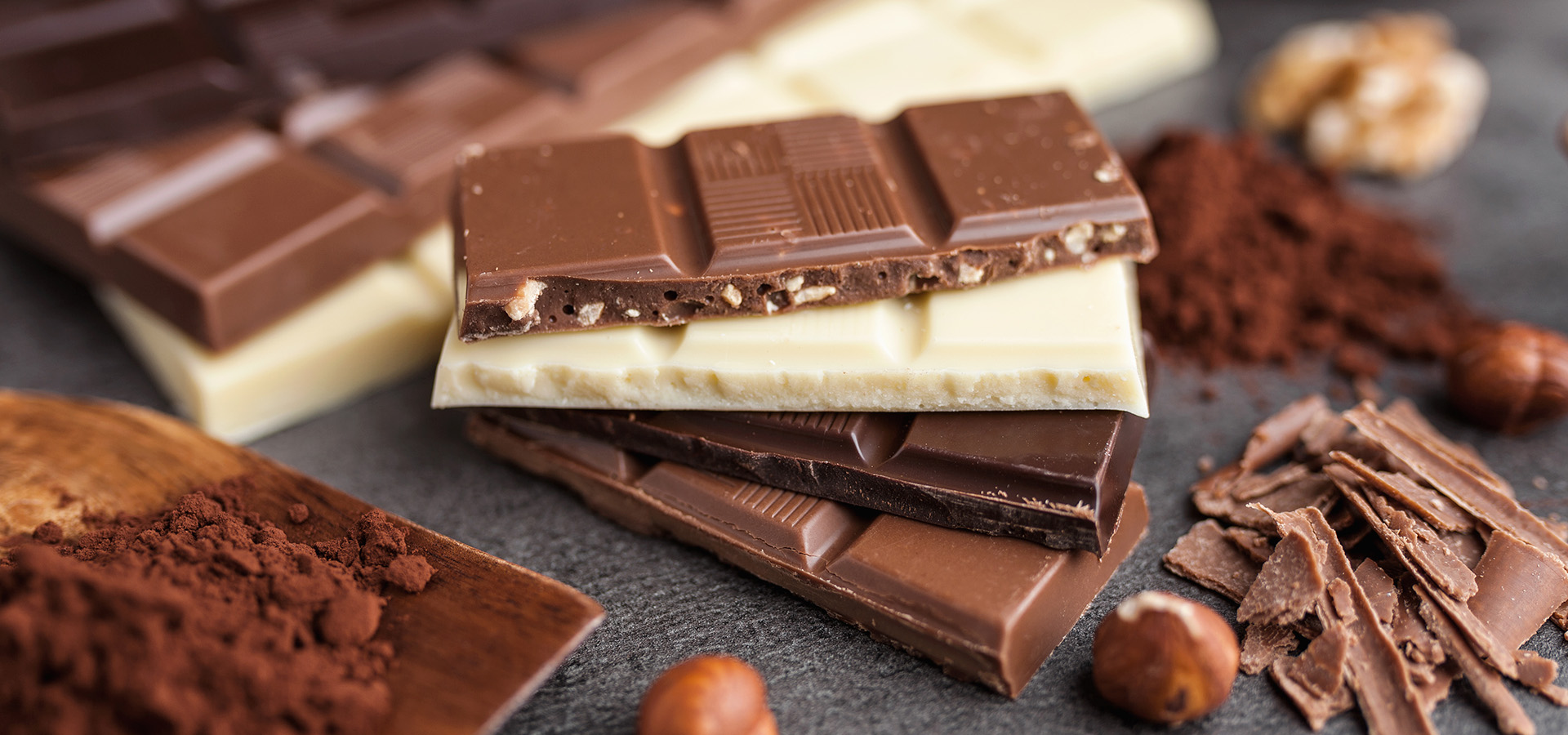 Photograph of different kinds of chocolate bars stacked on top of each other