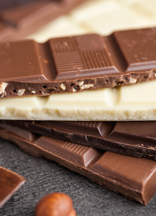 Photograph of different kinds of chocolate bars stacked on top of each other
