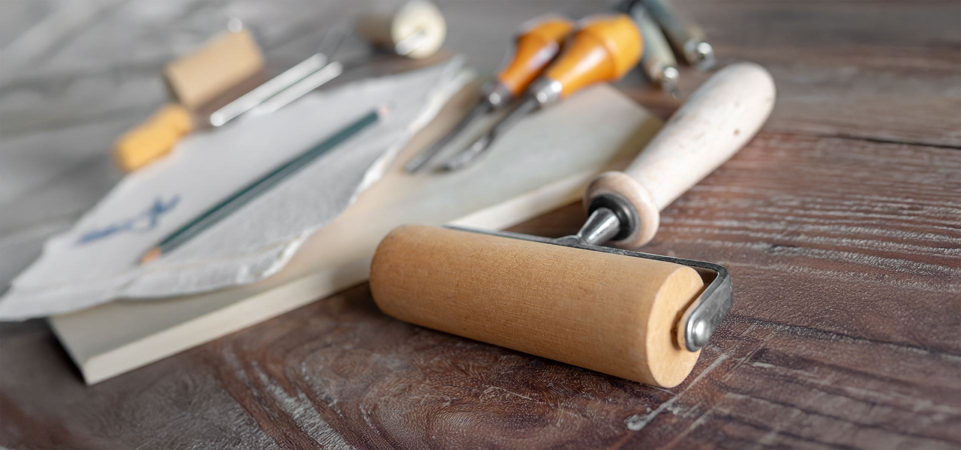 An array of woodcutting tools including carving tools and a roller.