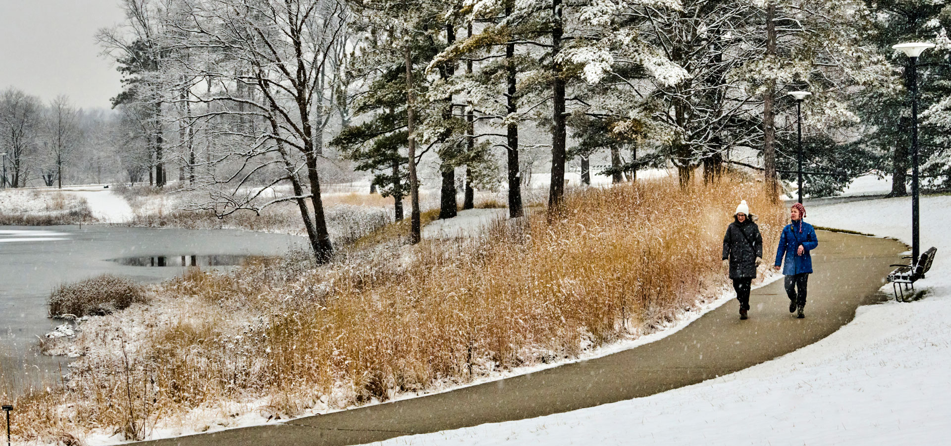 Friends walk around Meadow Lake after a light dusting of snow in winter.