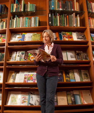 A woman reads a magazine in the Sterling Morton Library.