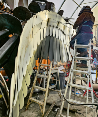 Artist's assistant welds metal 