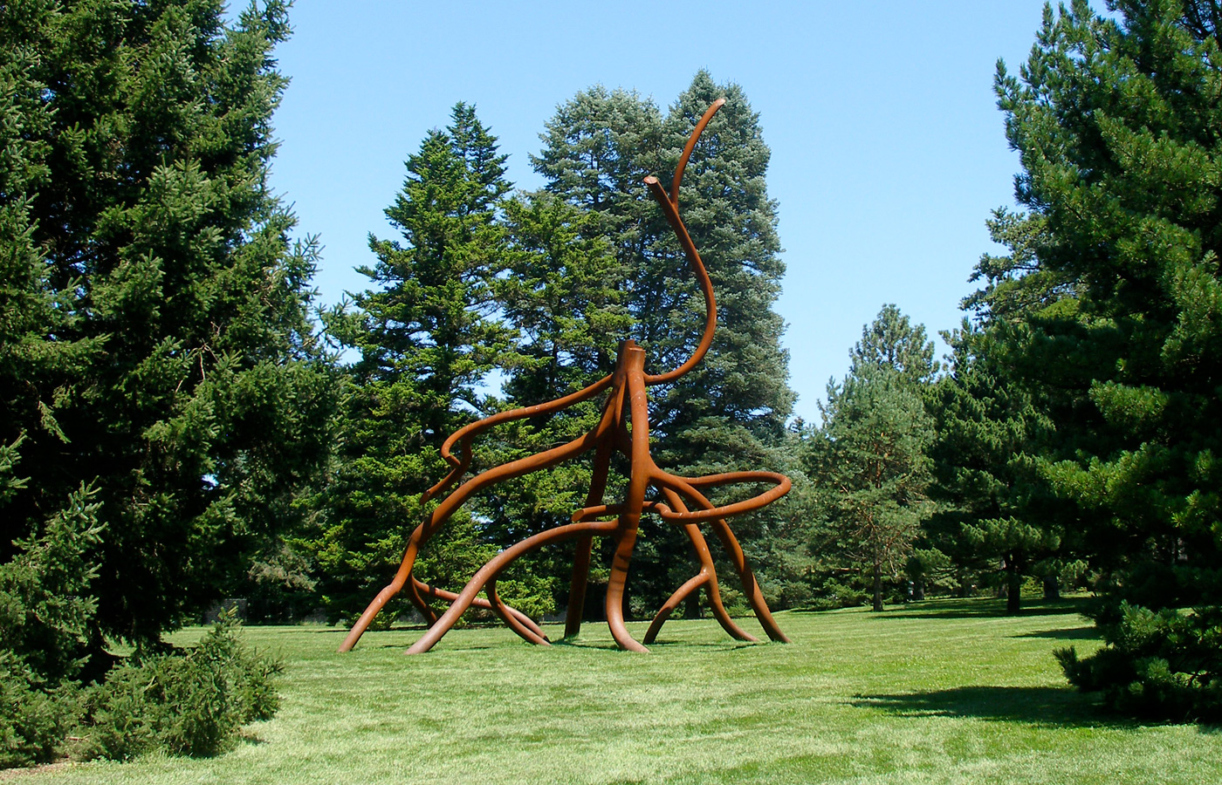 Large, abstract metal sculpture resembling tree roots