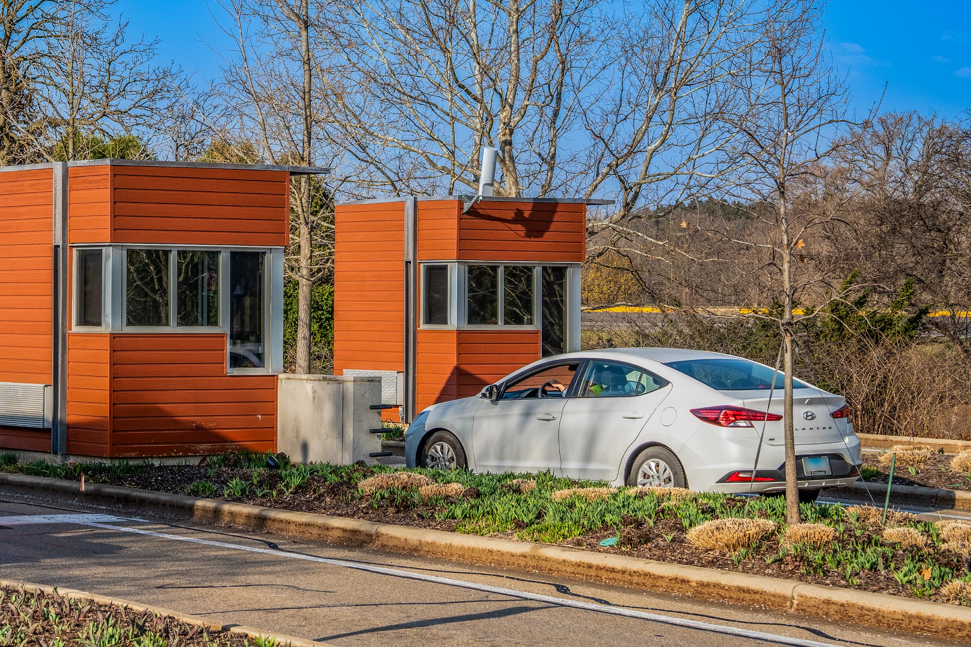 Photograph of a visitor car approaching the Gatehouse at The Morton Arboretum